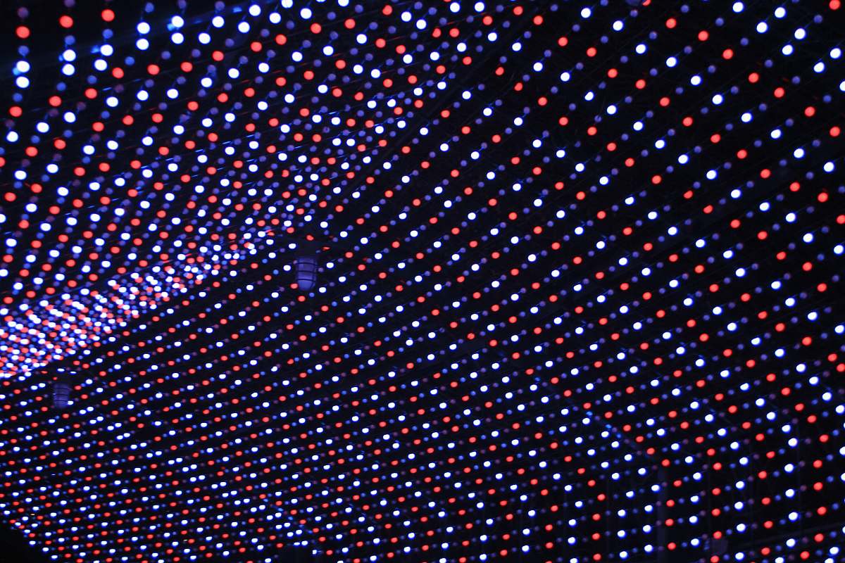 polka dot turned on white, blue, and red string lights at night rug